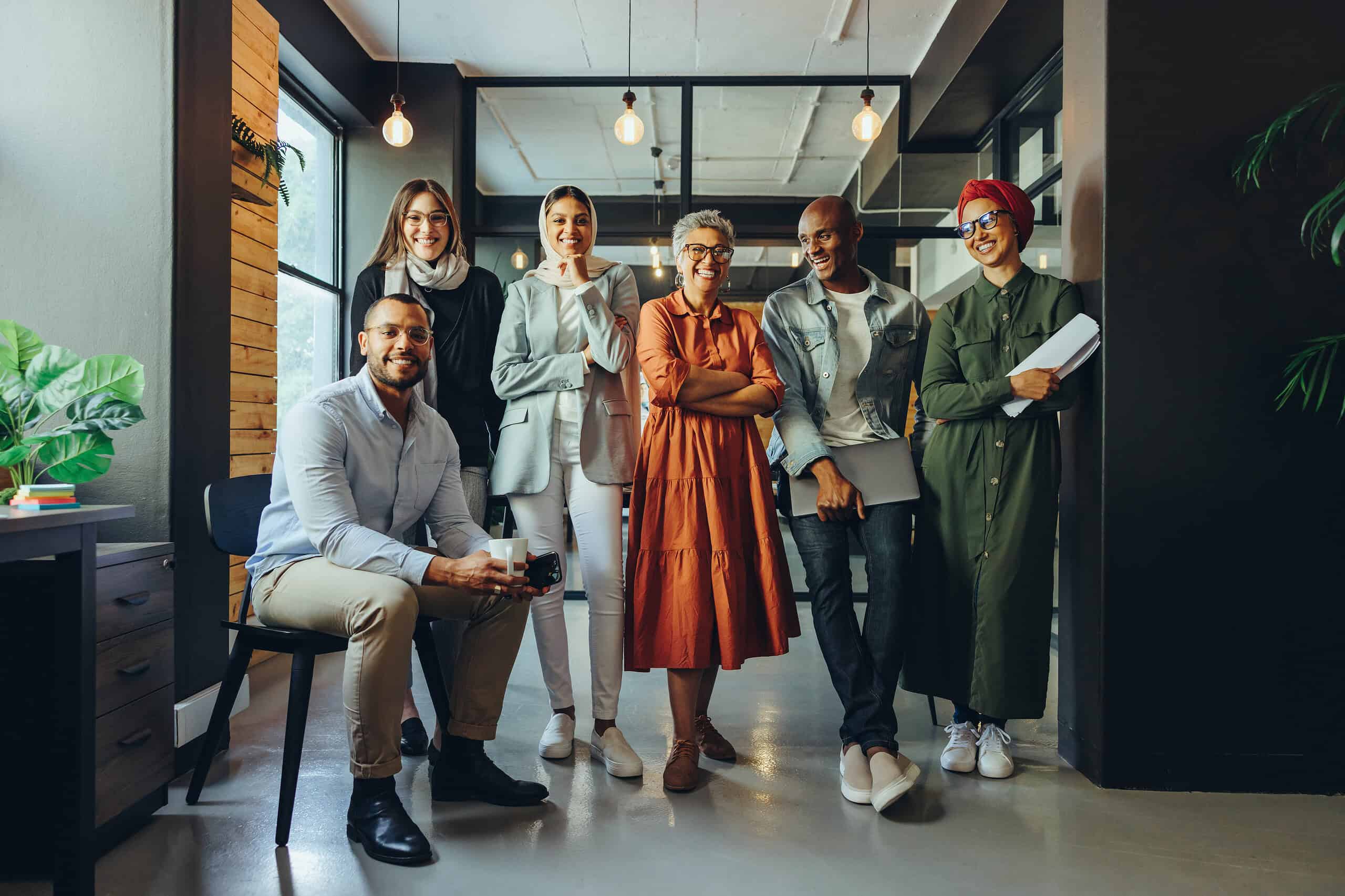 successful business team smiling at the camera in an office