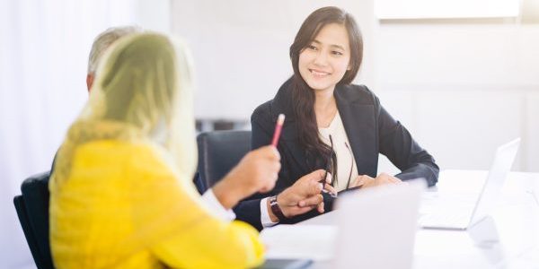 arab woman business partners brainstoming and discussing documents and planning business strategy in office room