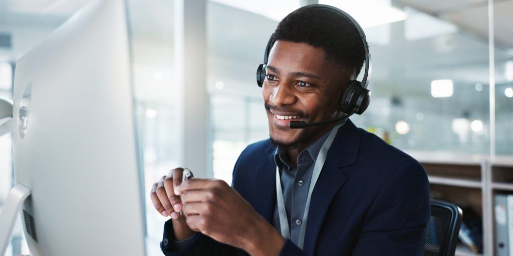 computer, call center and happy black man talking, crm and technical support at help desk. communication, customer service and sales agent consulting, telemarketing advisory and speaking to contact