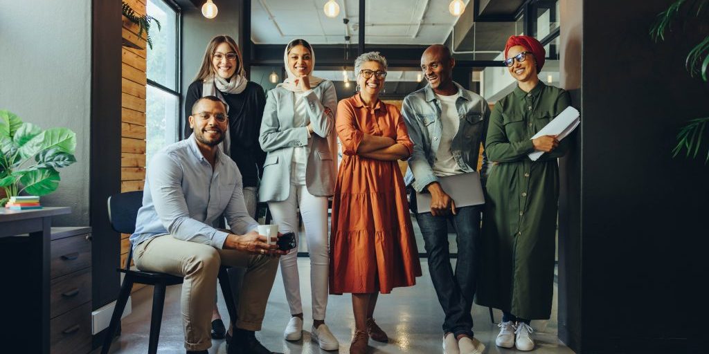 successful business team smiling at the camera in an office